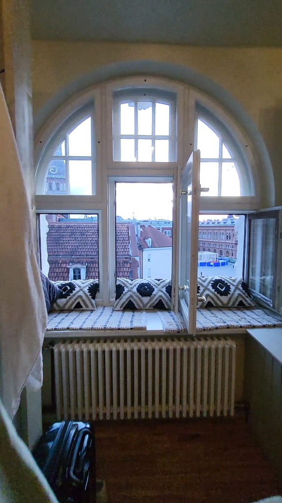 Window and hangout place in the dormitory in Blue Bird hostel, Riga.